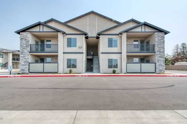 Two-story residential buildings with stone accents and balconies