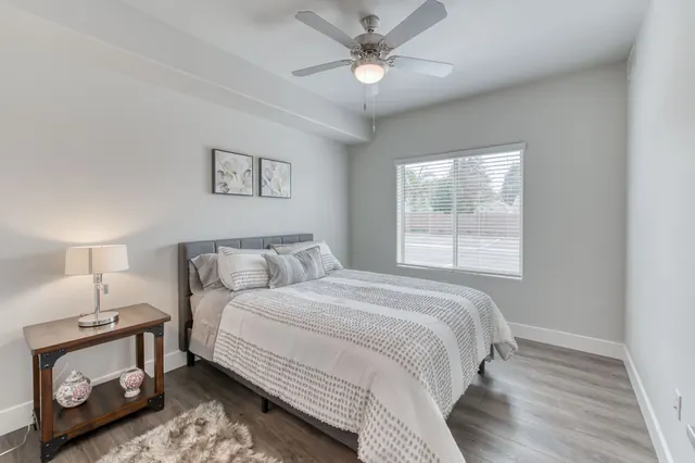 Bedroom with a ceiling fan and a large window
