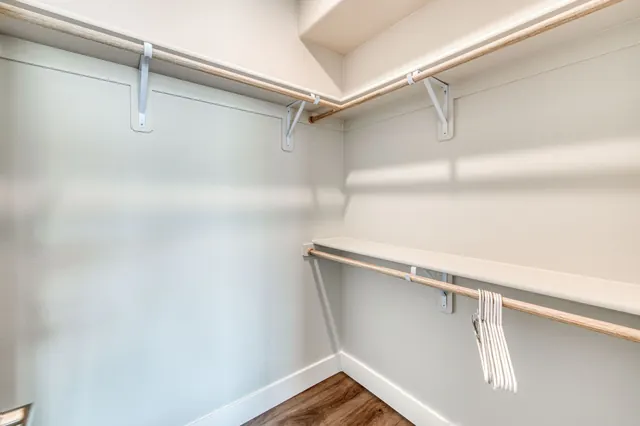 Walk-in closet with built-in shelving and hanging rods