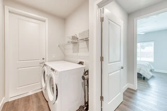 Hallway laundry with a full-size washer and dryer