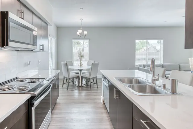 Kitchen island with a double sink looking toward the dining area