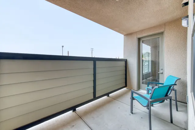 Private balcony with a teal patio chair
