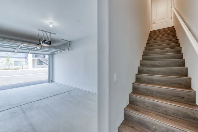 Garage with stairs leading into the home