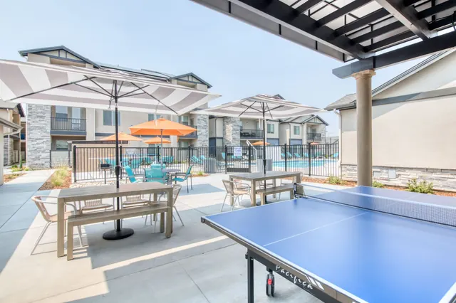 Table tennis and dining tables beside the pool