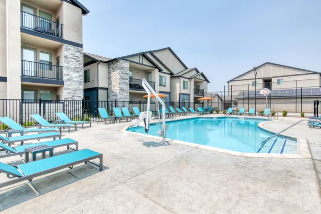 Pool deck lined with teal lounge chairs