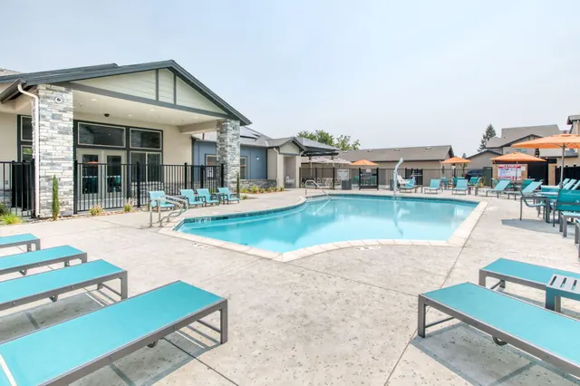 Pool deck with lounge chairs and umbrellas