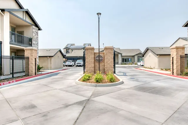 Gated vehicle entry with stone pillars