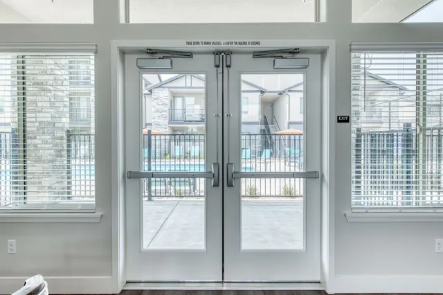 Clubhouse glass doors opening to the pool