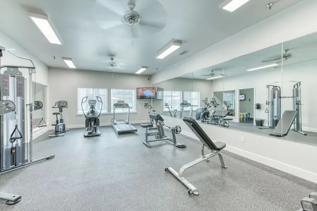 Fitness center with a weight bench, cable machine and cardio equipment