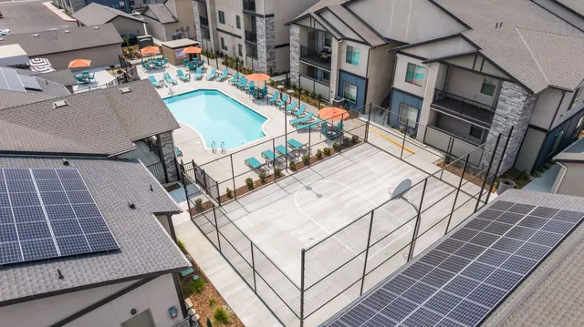 Aerial view of the pool deck, orange umbrellas and sport court