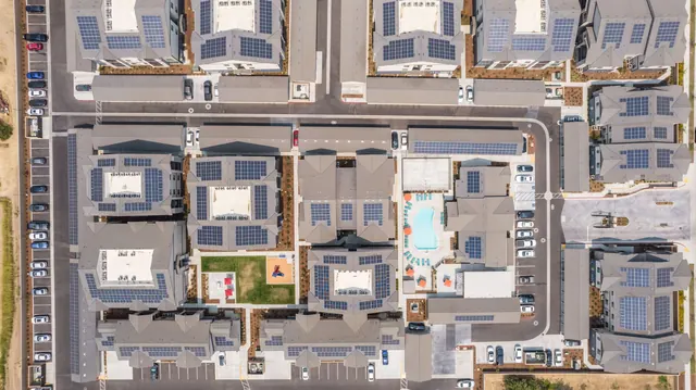 Overhead view of buildings, garages and rooftop solar panels